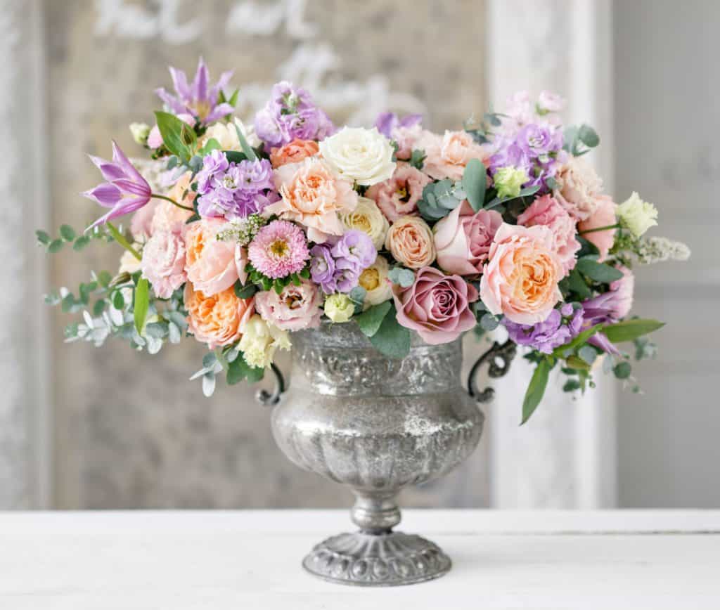 pink peach and purple pastel flowers in silver vase