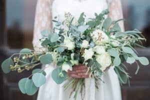 Bridal bouquet with an abundance of eucalytpus leaves andn white flowers