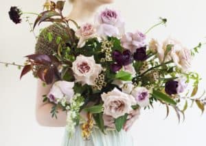 Winter bridal bouquet with dusty colored blooms in light peaches and burgundies