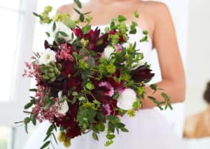 dramatic dark blooms in burgundy and wine with green accents