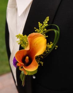 Orange Calla Lily boutonniere on black suit