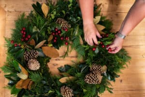 Putting winter berries in Christmas wreath