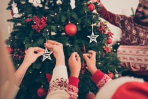 Decorating the Christmas tree with winter berries