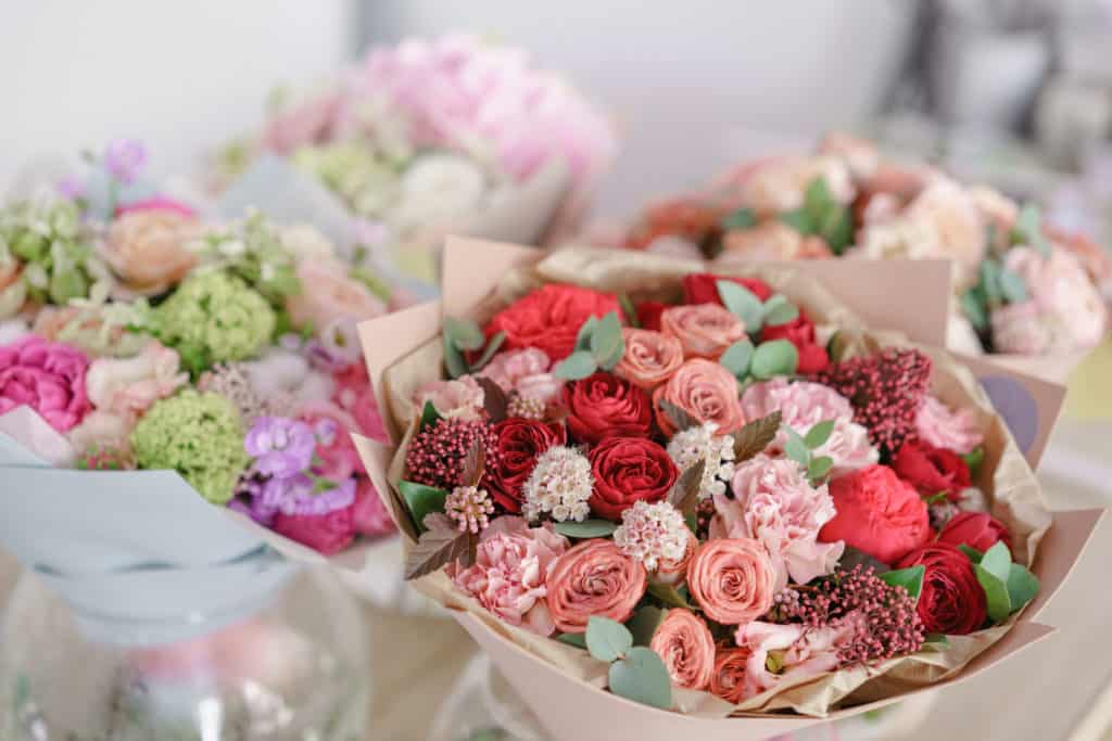 Multiple flower arrangements in various colors