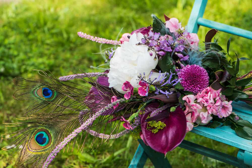Flower arrangement with peacock feathers