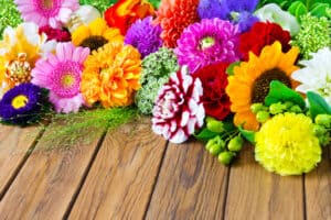 Bright flowers on wooden surface