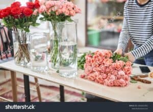 Pink and red roses in large vases