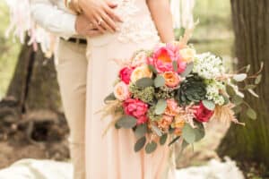 Bride and groom with boho wedding bouquet