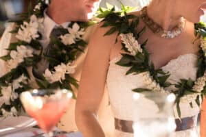 Bride and groom wearing leis