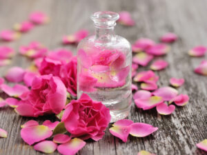 Rose blossoms and petals with glass bottle