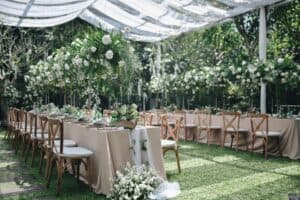 Outdoor garden party venue with white floral decor