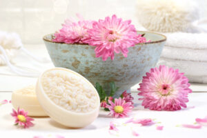 Pink chrysanthemums in bowl with soap