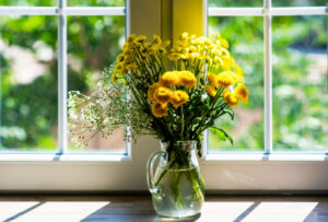 Bouquet of yellow flowers by window