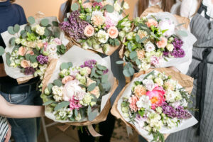 Women holding up floral bouquets