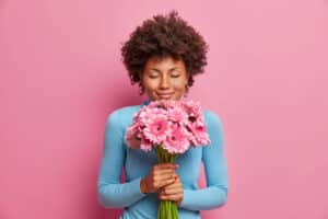 Woman with bouquet of pink gerbera daisies