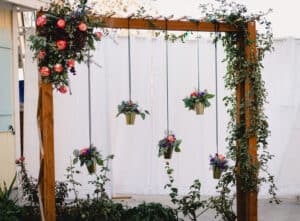 Wedding arch with floral decor and hanging flowering plants
