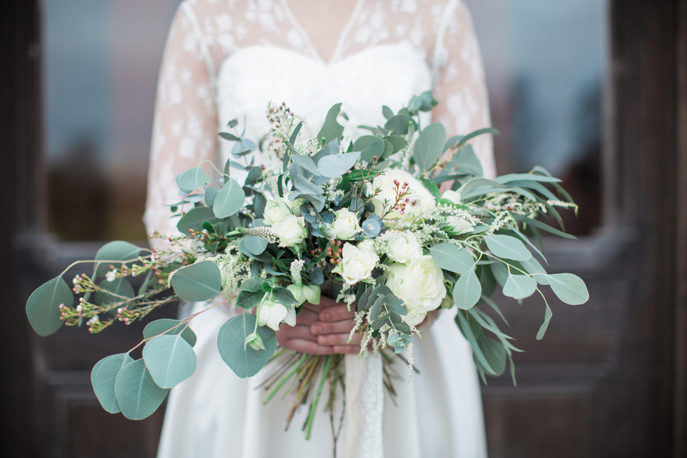 Bride holding meadow-like bouquet