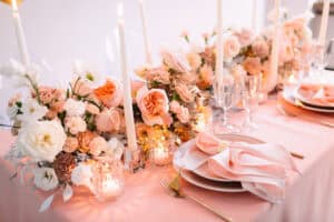 Table set with peach fuzz flowers
