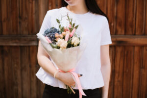 Woman holding bouquet with bunny tails