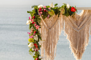 Tropical flowers adorning arch by the sea