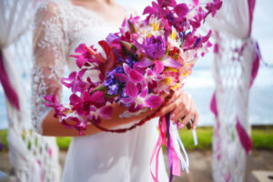 Bride holding bouquet with orchids and alstroemeria