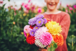 Girl holding dahlia bouquet