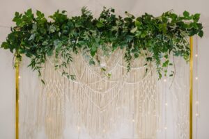 Greenery and macrame on a yellow wedding frame