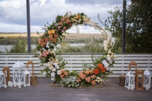 Round floral arch at outdoor wedding