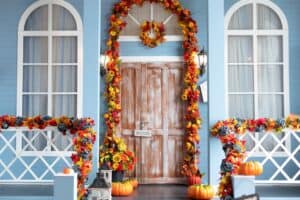 Outdoor porch decorated with flower garlands and pumpkins