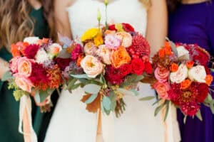 Bride and bridesmaids with fall rose bouquets