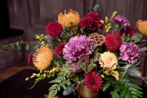 Moody flower arrangement with proteas and dahlias