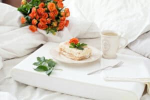 Breakfast in bed with orange roses