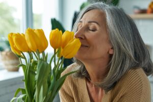 Woman smelling yellow tulips