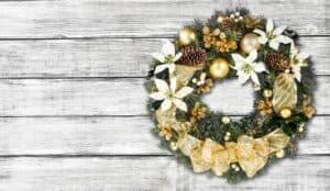 Holiday wreath with pinecones and gold ribbon