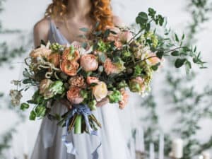 Woman holding large bouquet of flowers