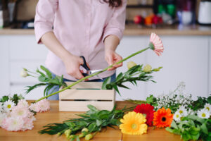 Woman working with bright gerbera daisies