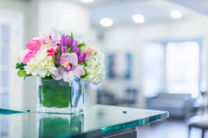 Flowers on glass table in glass vase