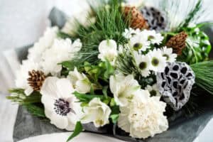 Winter flowers with anemones, carnations, daisies, and pine