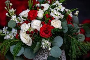 Red and white roses with festive greenery