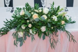 A eucalyptus heavy sweetheart table arrangement