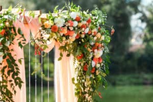 Colorful floral installation on standard wedding arch