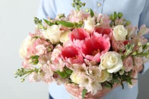 Woman holding bouquet with alstroemeria and other blooms