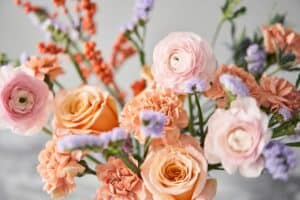 Peach roses with ranunculus and accent blooms