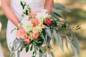 Bride holding dummy bouquet with cascading greenery
