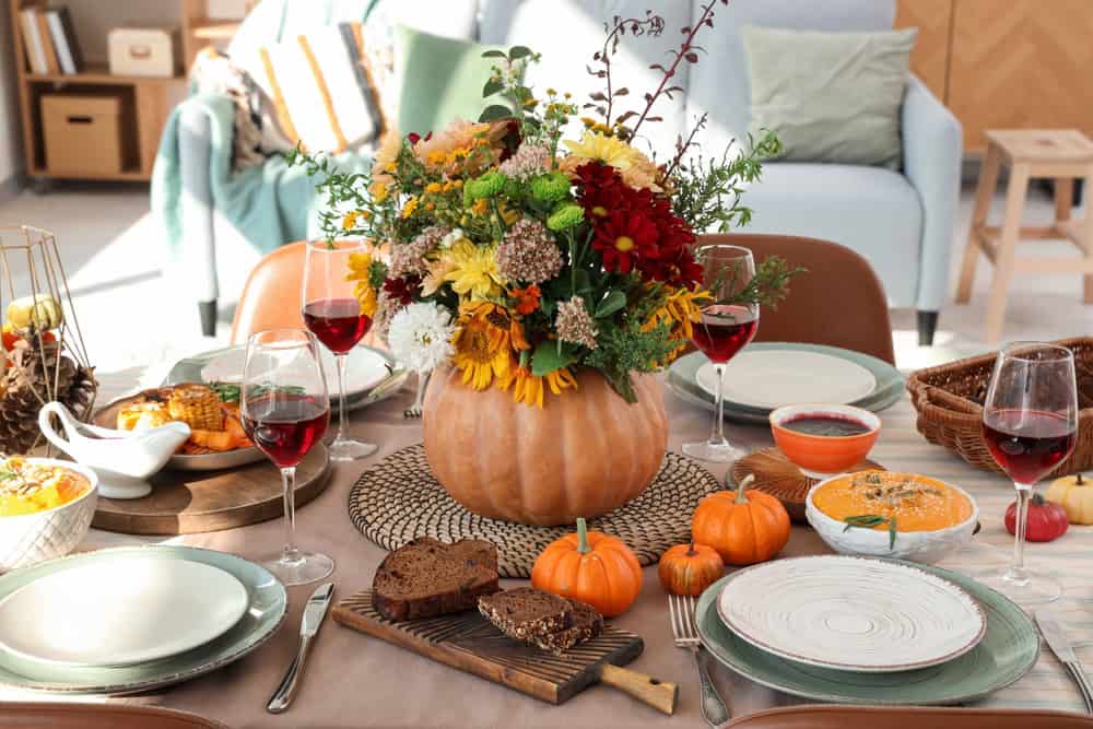 Autumn tables cape set with fall flowers in pumpkin