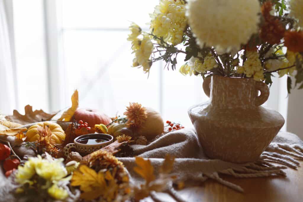 autumn cozy fall flowers in a rustic vase